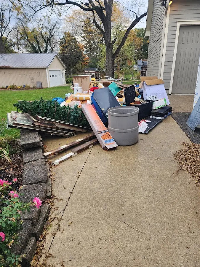 Dumpster being loaded with debris for Estate Cleanout Dumpster Rental in Oak Ridge